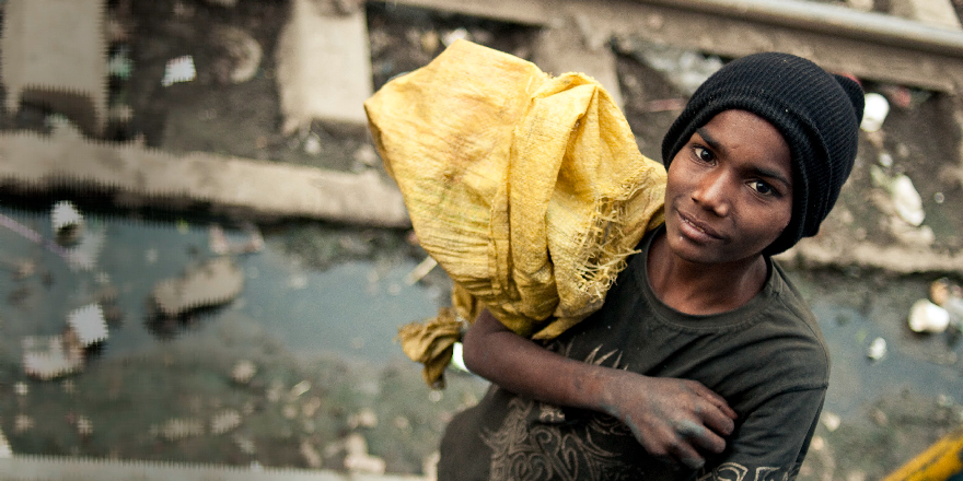 An Indian boy collecting litter on the railways